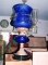 18 Oil Lamps on blue cut glass on brass stand